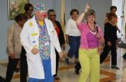 Reine Humeny (right) leads Dr. Gismo, one of Shore Memorial’s Caring Clowns, and others in line dancing during the hospital’s National Cancer Survivors Day Celebration on June 7.